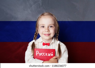 Learn Russian Language. Child Girl Student With Book Against The Russian Flag Background