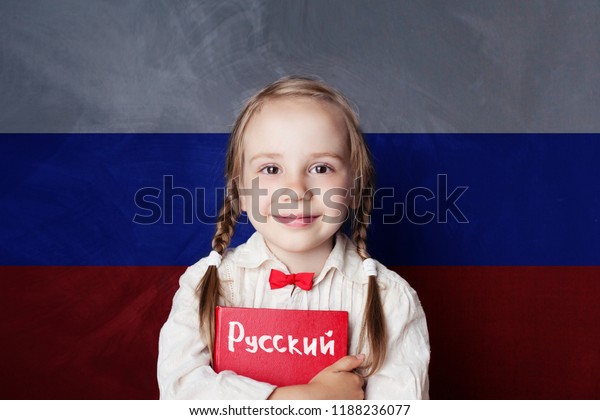 Learn russian language. Child girl\
student with book against the russian flag\
background