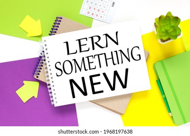 Learn Something New. notepad on a colorful background. white purple and yellow background.
