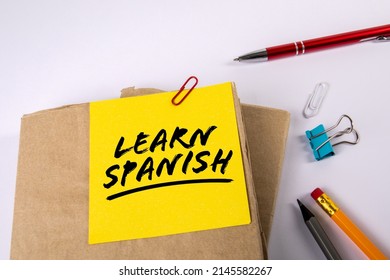 Learn Spanish. Textbooks and stationery on a white background.