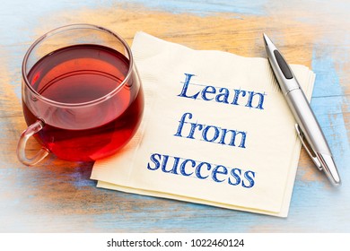 Learn from success advice - handwriting on a napkin with a cup of tea - Shutterstock ID 1022460124