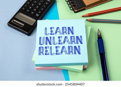 Learn Unlearn Relearn Concept. Notepad with text on office table.