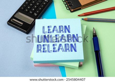 Learn Unlearn Relearn Concept. Notepad with text on office table.