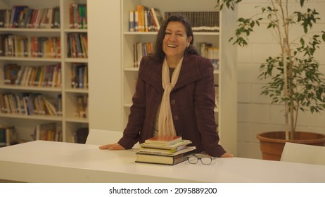 Learned Experienced Argentinian Teacher Smiling At A Library