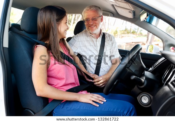 Learner driver\
girl with instructor taking\
lessons