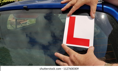 learner l plate sticker on rear window of car 