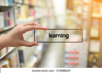 Learning - concept of hand holding box with the word on blurred bookstore as background