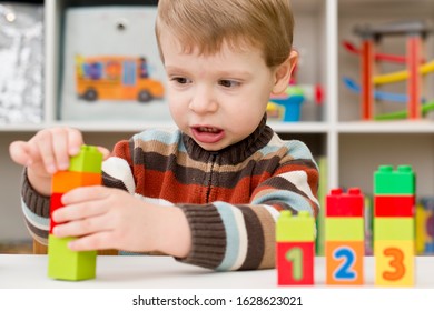 Learning to count. 2 year old boy stacking  Duplo blocks. children, infancy and education concept. formation and development of the child. Montessori and early development