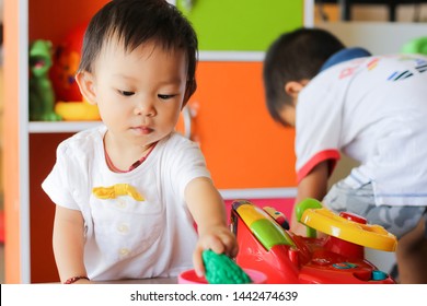 Learning And Development Of Baby Aged One Year Old. Happy Asian Child Girl Playing With Many Toys At The Room.