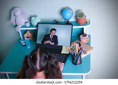 Learning Distance Internet Online By Using A Computer. Asian Kid Girl Learning Education Online Studying Through Computer Screen With Male Teachers Teaching At Home. Concept Education Social Distance.