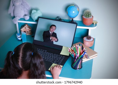 Learning Distance Internet Online By Using A Computer. Asian Kid Girl Learning Education Online Studying Through Computer Screen With Male Teachers Teaching At Home. Concept Education Social Distance.