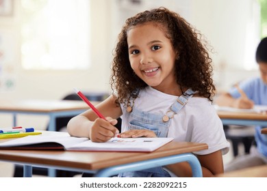 Learning, drawing and portrait of girl in classroom exam, education or studying with book. Preschool smile, development and happy kid or student coloring for creative art in notebook in kindergarten. - Shutterstock ID 2282092215