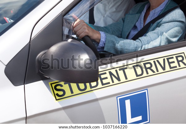 Learning to drive a car with a driving\
instructor. Student\
driver.