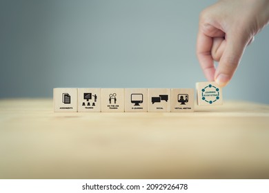 Learning ecosystems concept. Building a blended learning ecosystems. Necessary for digital evolution and transformation.  Hand holds wooden cubes with text"Learning Ecosystems"on grey background. - Shutterstock ID 2092926478