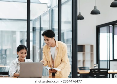 Learning, education and school concept. Young woman and man studying for a test or an exam. Tutor books with friends. Young students campus helps friend catching up and learning. - Shutterstock ID 2364476477