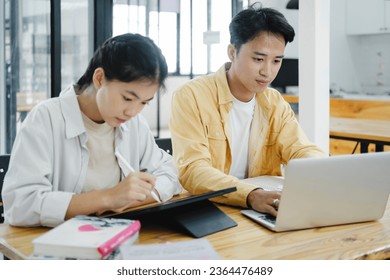 Learning, education and school concept. Young woman and man studying for a test or an exam. Tutor books with friends. Young students campus helps friend catching up and learning. - Shutterstock ID 2364476489