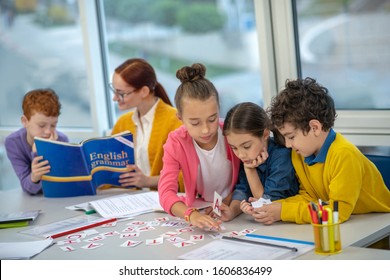 Learning English. Concentrated Children Learning English Grammar At School