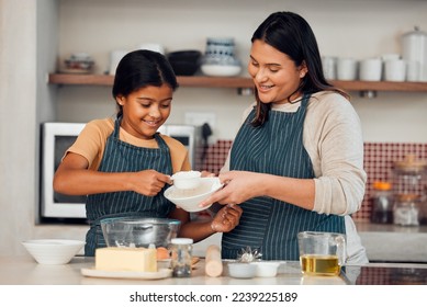 Learning, family and cooking cake with mother for bonding, wellness and help with smile. Happy family, kitchen and mom teaching young daughter baking skill with flour measurement in home. - Powered by Shutterstock