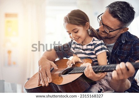 Learning, guitar and girl, man with smile for music or bonding or love or play at house. Happiness, teaching and kid, father with acoustic or musical instrument for fun or education at family home.