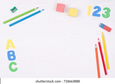 Learning how to read, write and count. Kid's desk with colorful letters, numbers and pencils, top view with copy space - Powered by Shutterstock