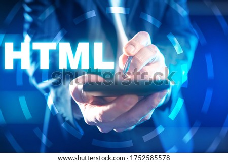 Learning HTML. Man learns HTML programming. HTML lettering next to the phone. Programmer holds phone in his hands. Man is learning programming languages. Programming training.  Online courses. School