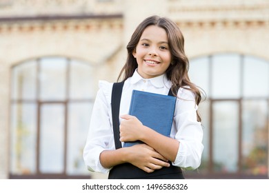 Learning language. Hooked on learning. School life. Child development. Excited about studying. School education concept. Cute smiling child hold book. Little girl school student. Knowledge day.