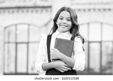 Learning language. Hooked on learning. School life. Child development. Excited about studying. School education concept. Cute smiling child hold book. Little girl school student. Knowledge day.