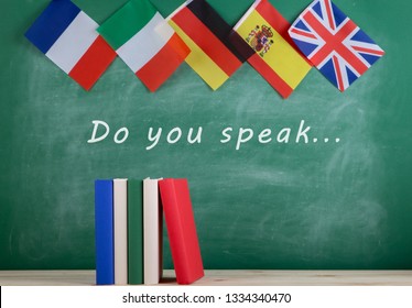 Learning languages concept - flags of Spain, France, Great Britain and other countries, blackboard with text "Do you speak..." and books