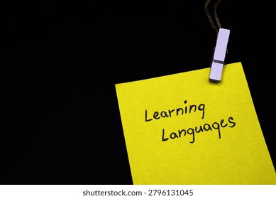 learning languages write on yellow card on black background 