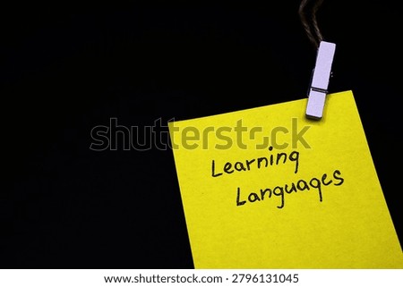 learning languages write on yellow card on black background 