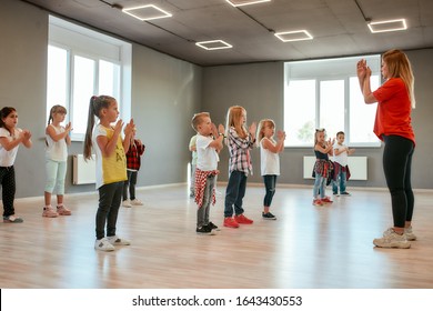 Learning A New Dance. Group Of Little Boys And Girls Dancing While Having Choreography Class In The Dance Studio. Dance Teacher And Children. Contemp Dance. Hip Hop. Kids And Sport. Full Length