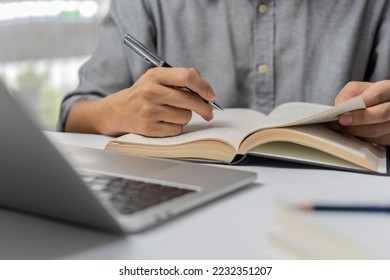 learning online class by using laptop computer and writing notebook at workplace, Education development or knowledge improvement concept. - Shutterstock ID 2232351207