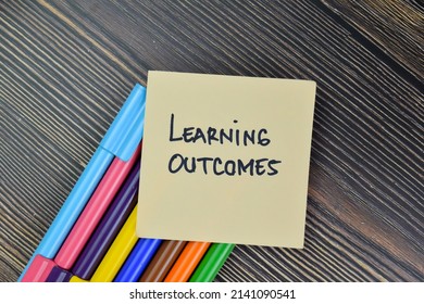 Learning Outcome Write On Sticky Notes Isolated On Wooden Table. Selective Focus On Learning Outcome Text