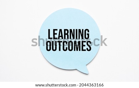 Learning outcomes speech bubble and black magnifier isolated on the yellow background.
