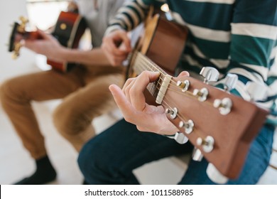 Learning to play the guitar. Music education and extracurricular lessons. Hobbies and enthusiasm for playing guitar and singing songs. - Shutterstock ID 1011588985