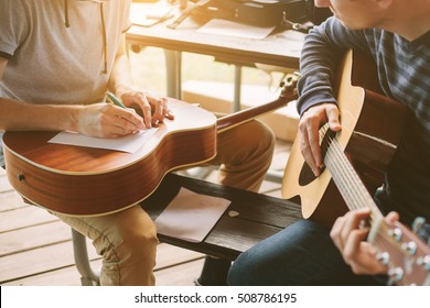 Learning to play the guitar. Music education and extra-curricular lessons. - Powered by Shutterstock