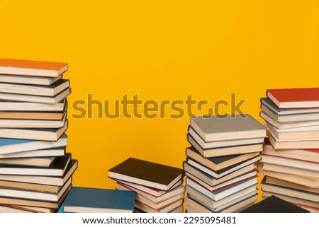a learning science stack of books in the library on a yellow background education