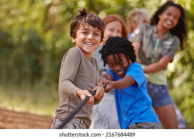 Learning teamwork through play. A group of kids in a tug-of-war game. - Shutterstock ID 2167684489