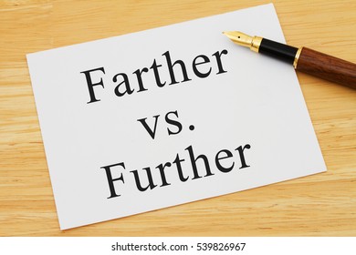 Learning to use proper grammar, A white card on a desk with a pen with words Farther vs Further
