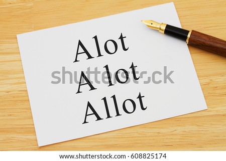 Learning to use proper grammar, A white card on a desk with a pen with words Alot, A lot and Allot
