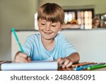 Learning, writing and boy with homework, education and creative assignment for child development with smile. House, student and book to practice handwriting, spelling and grammar with art project