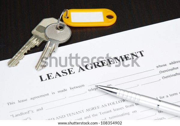 Lease agreement\
document with keys and\
pen