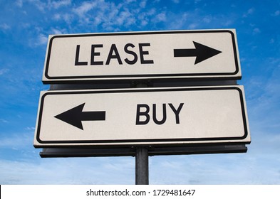 Lease vs buy. White two street signs with arrow on metal pole with word. Directional road. Crossroads Road Sign, Two Arrow. Blue sky background. Concept for own property versus borrow it.