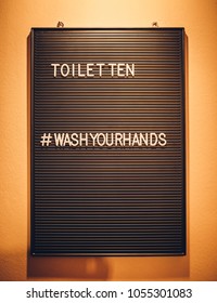 Lease Wash Your Hands - Sign On Against Orange Wall