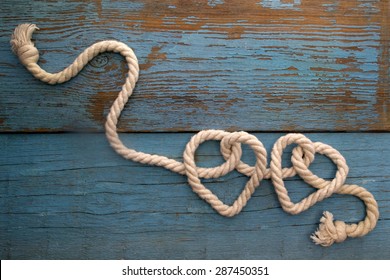 Leash  Rope Into Heart Shape On Wooden Table 