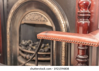 Leather Antique Corner Seating And Fire Surround With Brass Studs. Iron And Brass Fire Place And Mantle Piece Blurred In The Background. Luxurious Interior. Photo Taken In Rossendale On 16 November 20