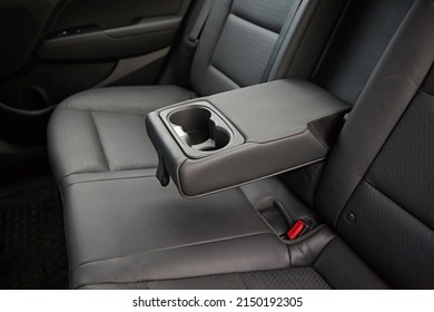 Leather armrest for storing things, moves and opens in the interior of the car. - Shutterstock ID 2150192305