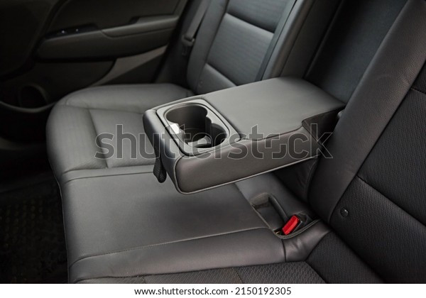 Leather armrest for storing things, moves and opens\
in the interior of the\
car.
