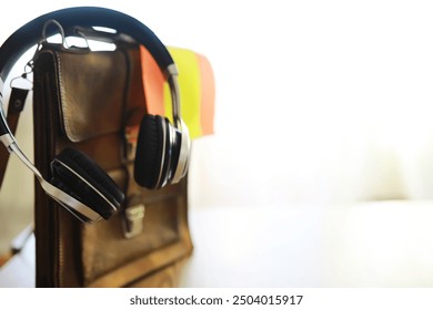 Leather Bag with Headphones - Modern Workspace Essentials - Powered by Shutterstock