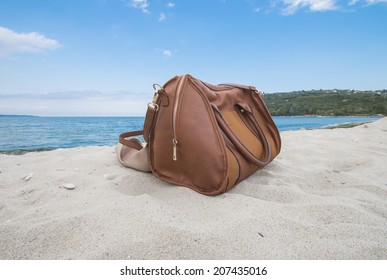 Leather Bag And Shoes On The Beach